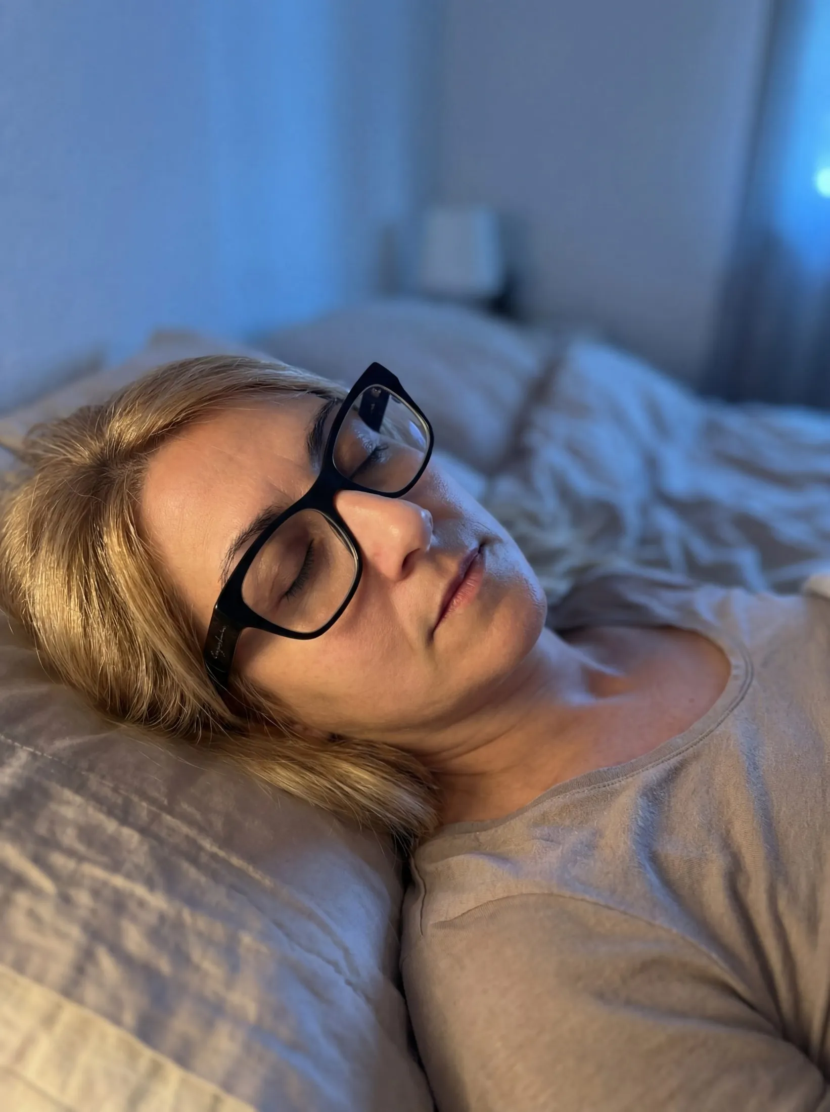 Melania lying in bed with her eyes closed, resting